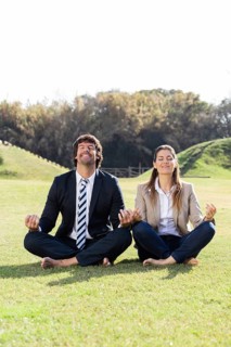 Cheerful businesspeople lotus position