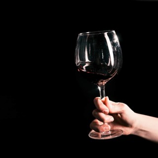 Crop hand with wineglass