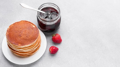 High angle delicious pancakes with jam