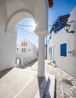 Chapel of Agios Antonios and archway with sun star of the Greek Orthodox church of Metamorfosi Sotiros