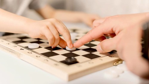 Close up kid playing chess