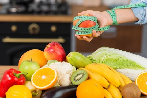 Close up person with fruits arrangement