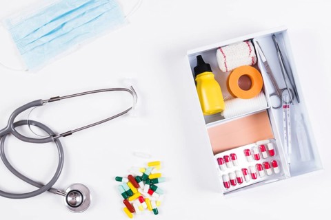 Colorful capsules stethoscope mask with first aid kits white background
