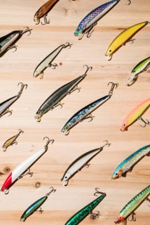 Diagonal colorful fishing lures wooden surface