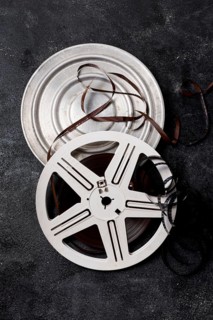 Film reel canister with negative stripes dark background