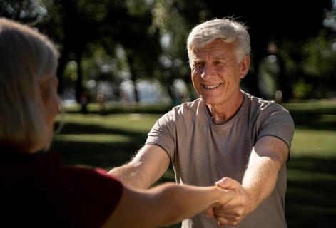 Smiley older couple exercising outdoors