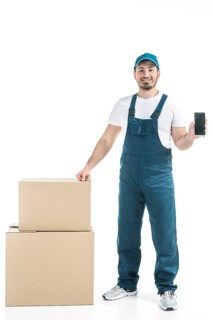 Friendly deliveryman showing smartphone