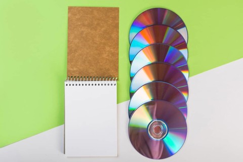 Spiral notepad with colorful compact discs green white dual background