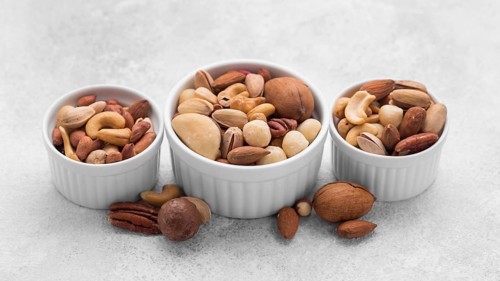 White small bowls filled with assortment nuts