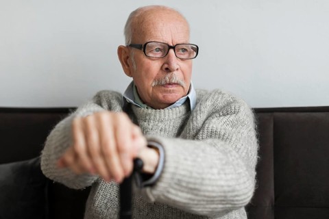 Old man nursing home with glasses cane
