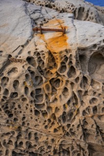 Rusty screw and stone structures in the Buca delle Fate