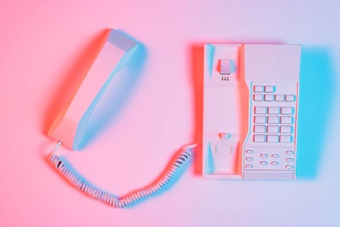 High angle view pink retro landline telephone with receiver