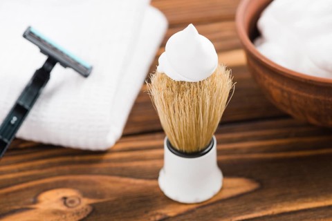 White foam shaving brush with razor napkin foam desk