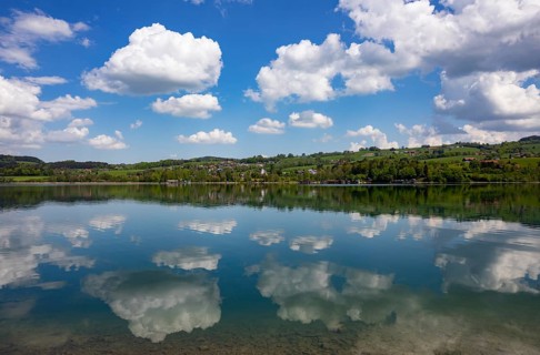 (Cumulus) clouds reflected in the Irrsee, Zell am moss, Salzkammergut, Upper Austria, Austria,