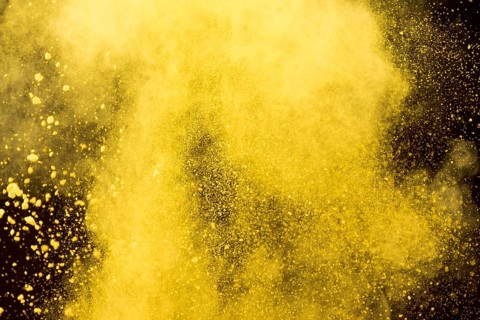 Yellow cloud cosmetic powder black background