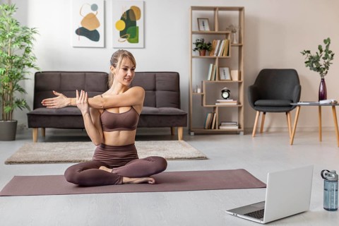 Young woman exercising home mat