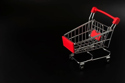 Shopping cart dark background with copy space