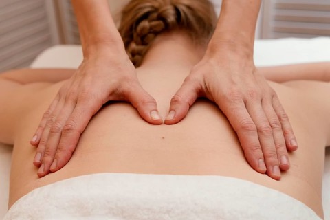 Close up therapist massaging back