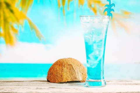 Glass cooling blue drink inverted coconut shell