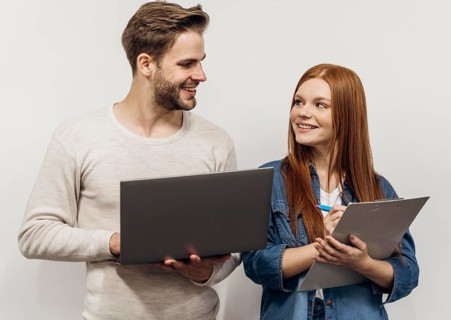 Redhead businesswoman working laptop with her coworker