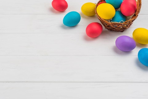 Basket with easter eggs wooden table