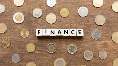 Finance word written scrabble letters coins