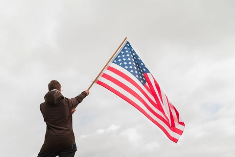 Man waving american flag