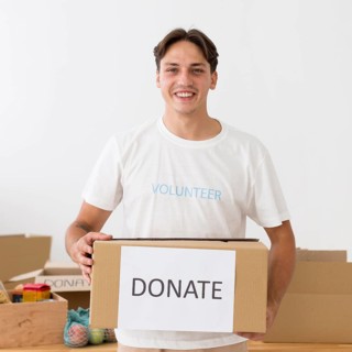 Happy volunteer holding donate box