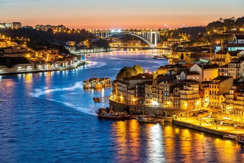 View over the river Douro to the old town of Porto and Vila Nova de Gaia at dusk