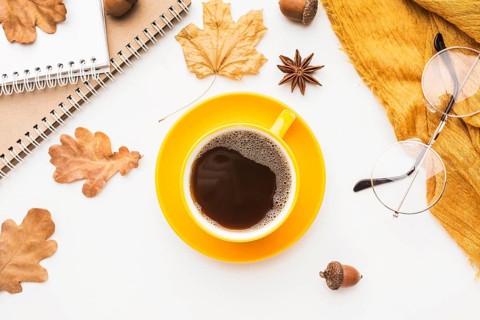 Top view coffee cup with glasses autumn leaves