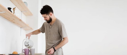 Man pouring hot water mugs