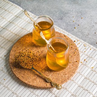 Two honey pots with bee pollens circular cork coaster
