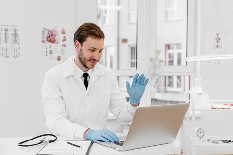 Medium shot doctor working laptop