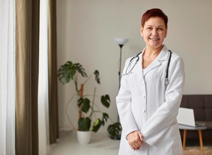 Front view elder smiley covid recovery center female doctor with copy space