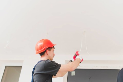 Man working with cables ceiling
