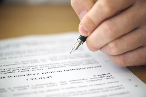 Close up hand signing contract
