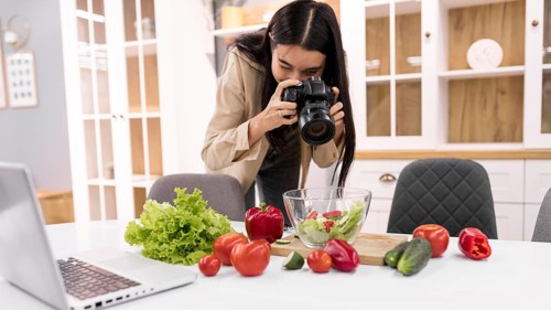 Female vlogger taking pictures with camera