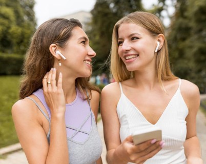 Girls wearing airpods park
