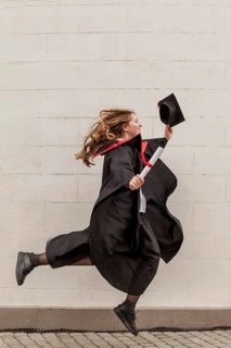 Side view girl jumping graduation