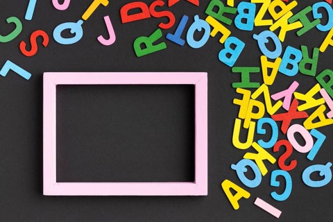 Flat lay frame with colorful letters
