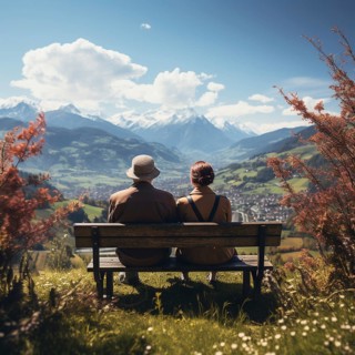 Retired couple sitting on a bench in the mountains and looking at the mountain panorama