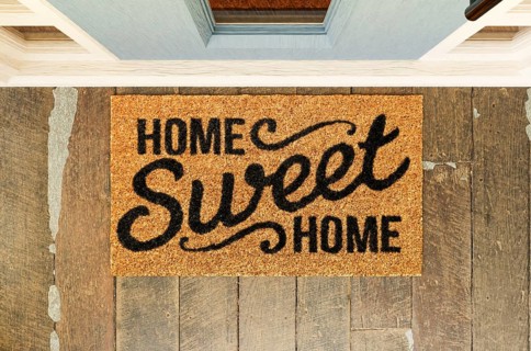 Home sweet home doormat on the porch at the front door