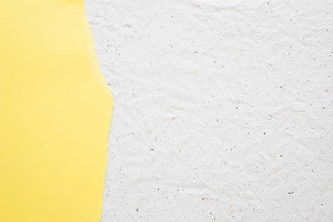 Yellow paper white old textured background