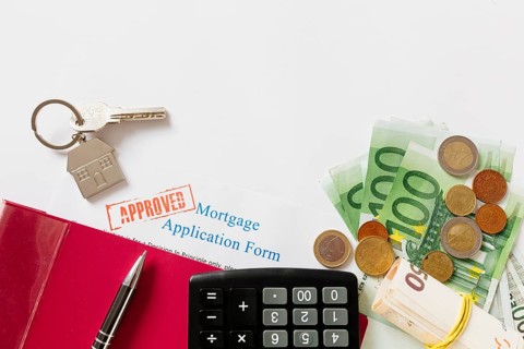 Approved mortgage contract key with money