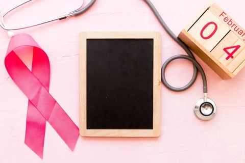 World cancer day awareness ribbon with stethoscope wooden slate 4th february wooden box