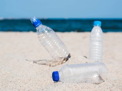 Plastic waste empty bottle sand beach
