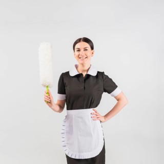 Maid with duster smiling