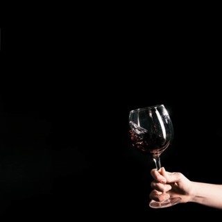 Crop hand holding glass wine