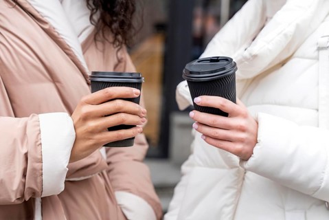 Close up hands holding coffee cups