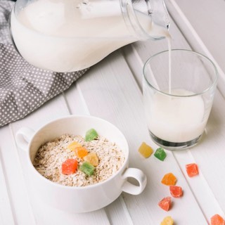 Overhead view oatmeal with glass milk white table